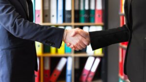 Two people shaking hands - Business Environment