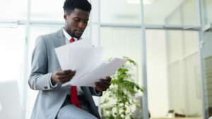 Man looking at financial papers - other